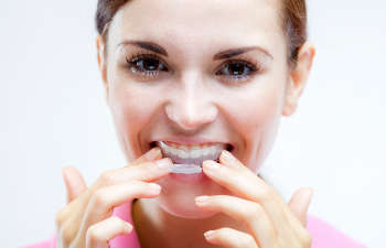 A young woman with braces on her teeth.