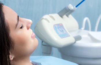 A relaxed sedated woman sitting in a dentist's chair before the treatment.