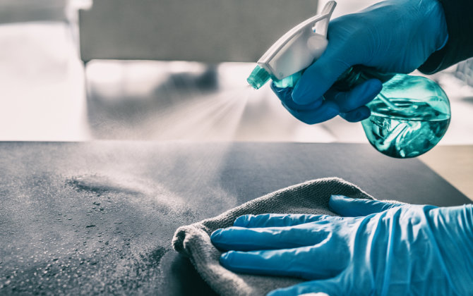 a person sterilizing surfaces between appointments at Marietta Dental Professionals, Marietta GA