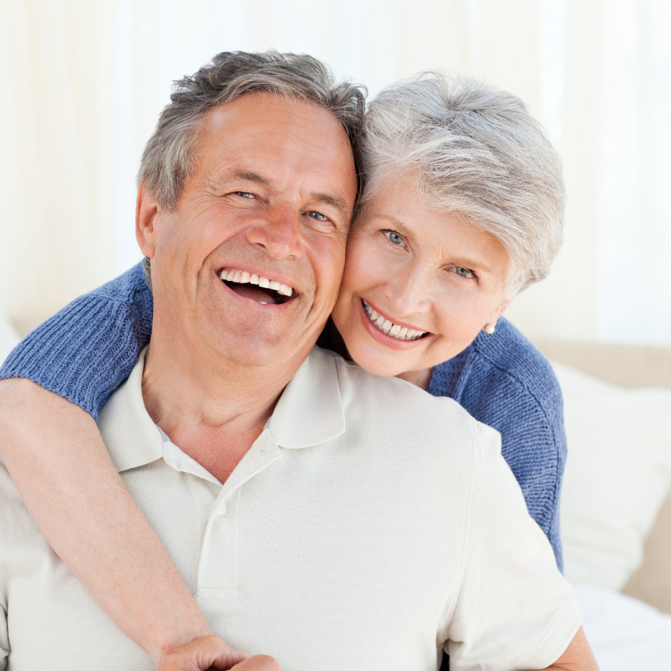 Confident broadly smiling senior couple