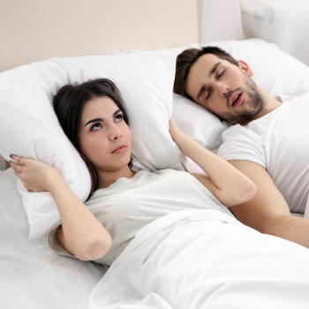 Young woman cant sleep because her partner is snoring