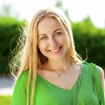 cheerful blond woman in a green blouse