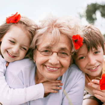 grandmother with granddaughters smiling warmly