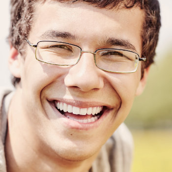 young man in glasses with a beautiful smile