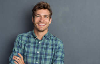 smiling young handsome man in a checkered shirt