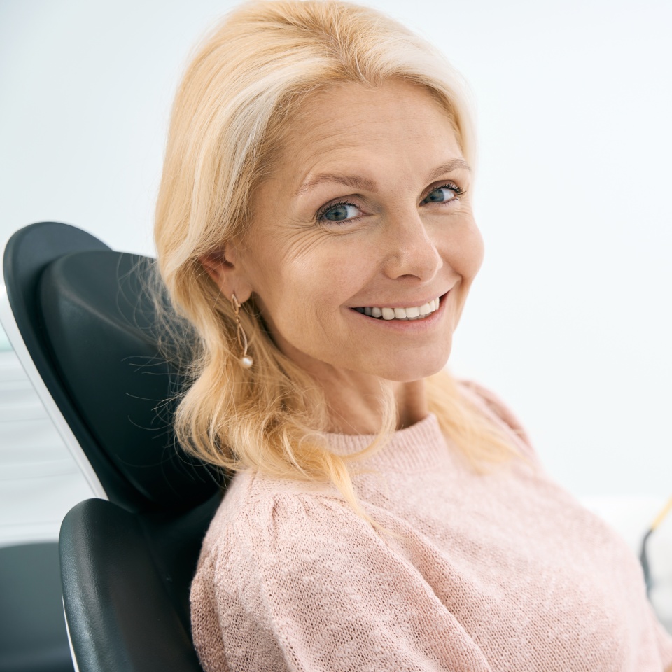 Pretty patient looking with smile in dental clinic