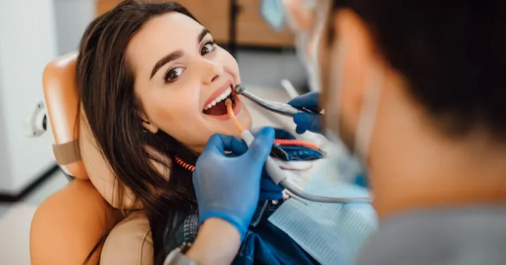 Smiling patient receiving dental checkup for cosmetic dentistry Marietta