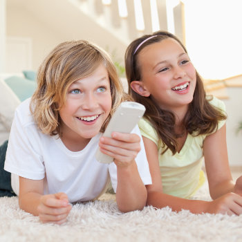 Pediatric Dentistry  Marietta siblings watching TV on floor care