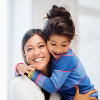 Happy mother hugging daughter Marietta Dental Professionals care