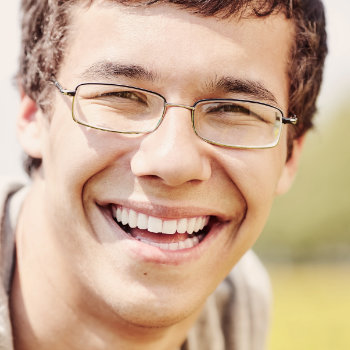 Young man with glasses smiling Marietta Dental Professionals patient