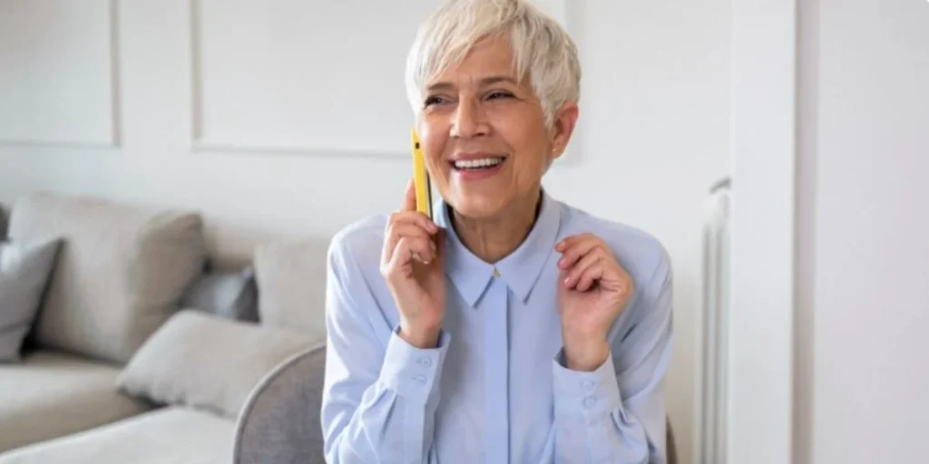 Happy woman consulting Dentist Membership Plan Marietta via phone call