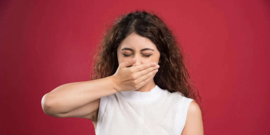 Young woman reacting to dry mouth bad breath and oral dryness