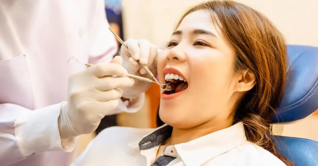Patient receiving restorative dental examination in clinic